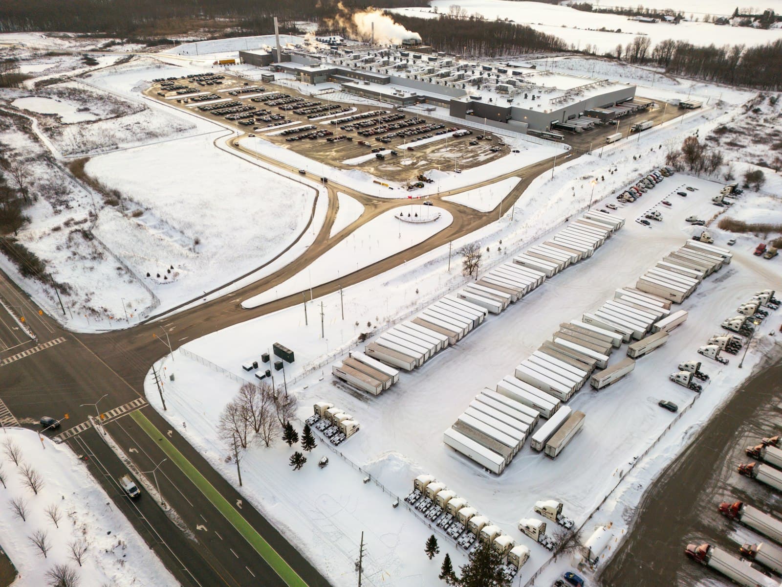 Aerial view of a snowy distribution yard with trailers